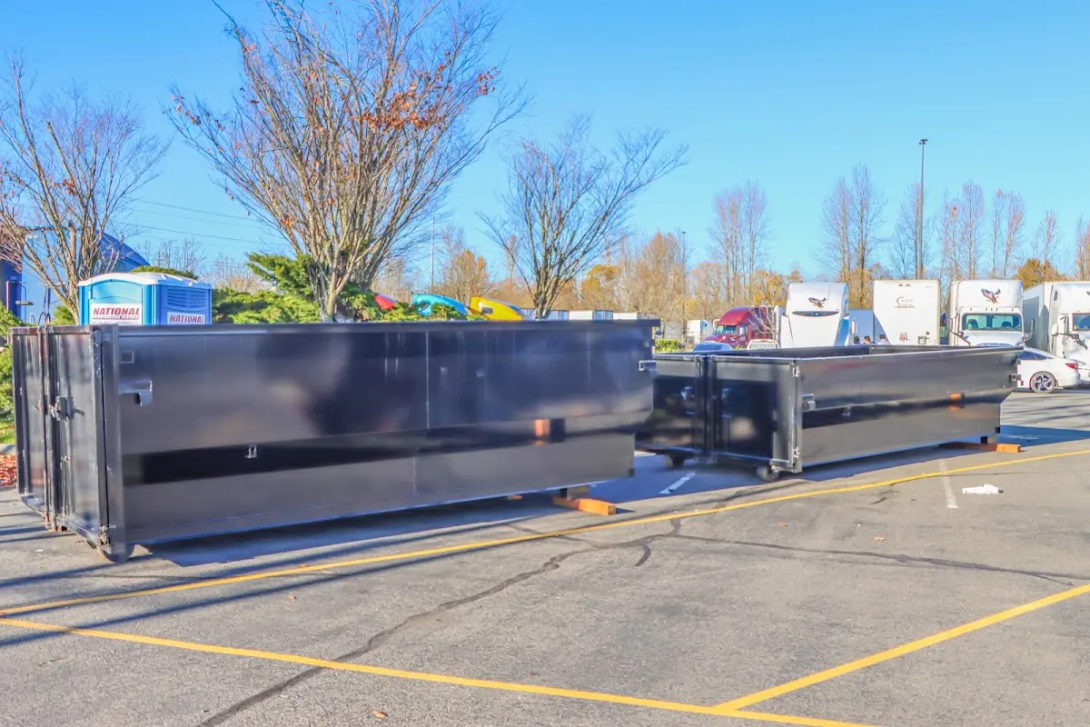 Professional dumpster rental service with roll-off container on residential driveway in Point Pleasant